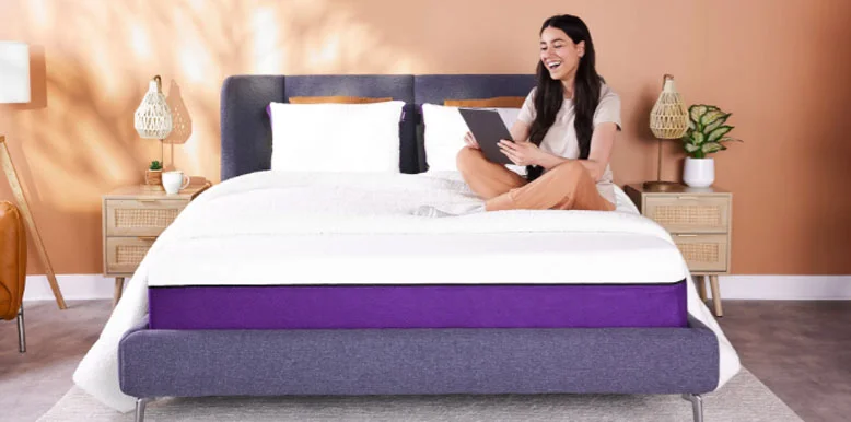 Our In-Depth Polysleep Bed Review for 2026 5 a happy lady is sitting on her polysleep mattress