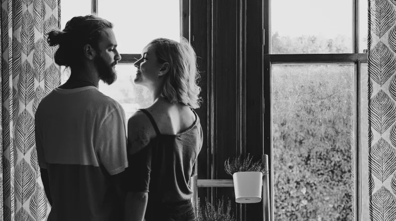 black and white photo of the couple standing close to each other
