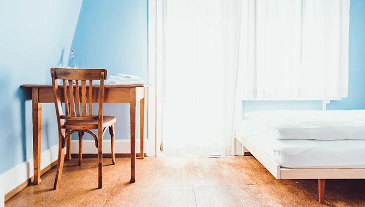 Blue bedroom with a desk and a chair from the wood