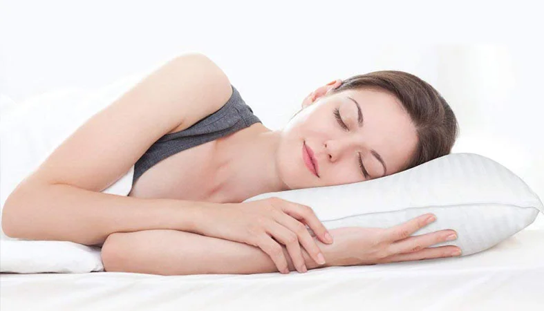 Down Pillows vs. Feather Pillows - What's the Difference? 5 woman is peacefully sleeping on the pillow