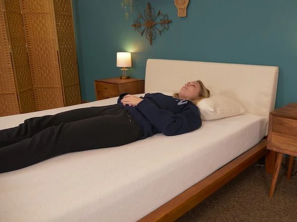 The 10 Best Mattress Toppers and Pads For 2026 13 Julia Forbes testing a mattress for back sleeping