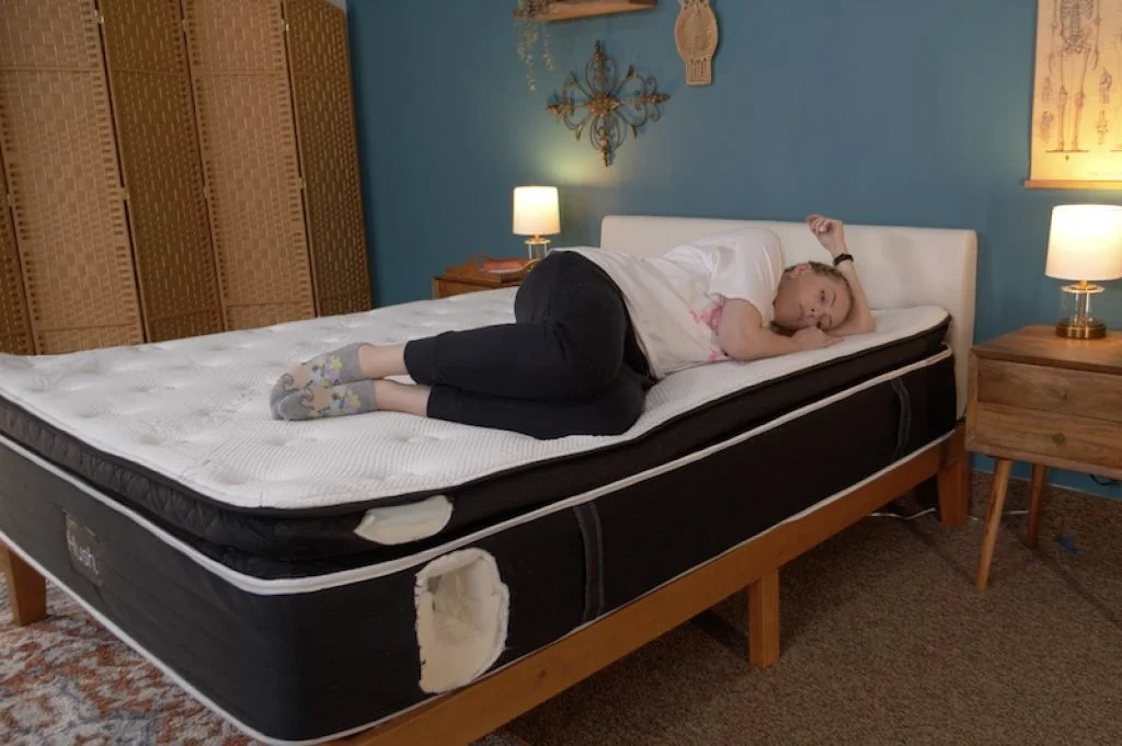 Best Mattress for People with a Herniated Disc - Medically Reviewed 182 Julia Forbes testing a mattress in the side sleeper sleeping position