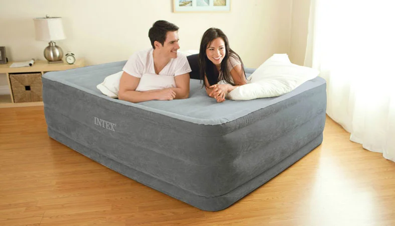 the couple laying on the air mattress in a bedroom
