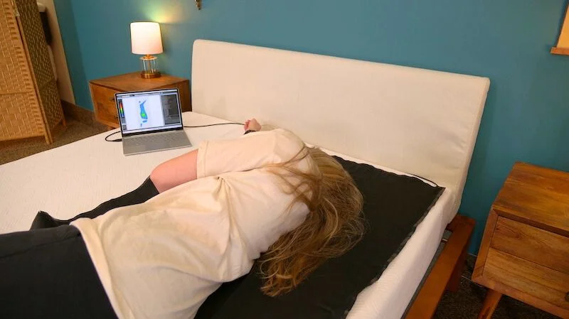 Julia Forbes testing a mattress for pressure relief