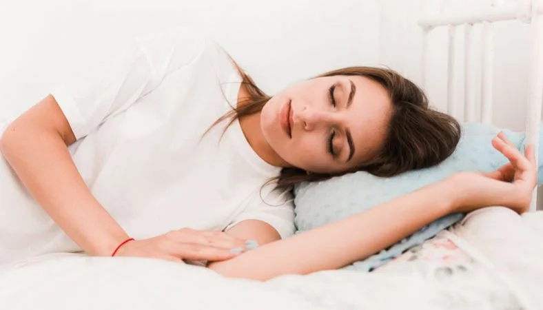 pretty woman is napping on bed