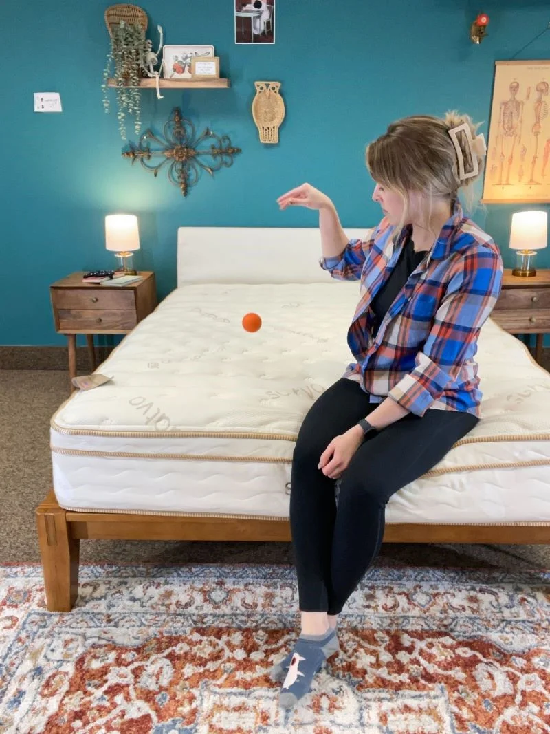 Using a ball to test the bounce of the Saatva mattress