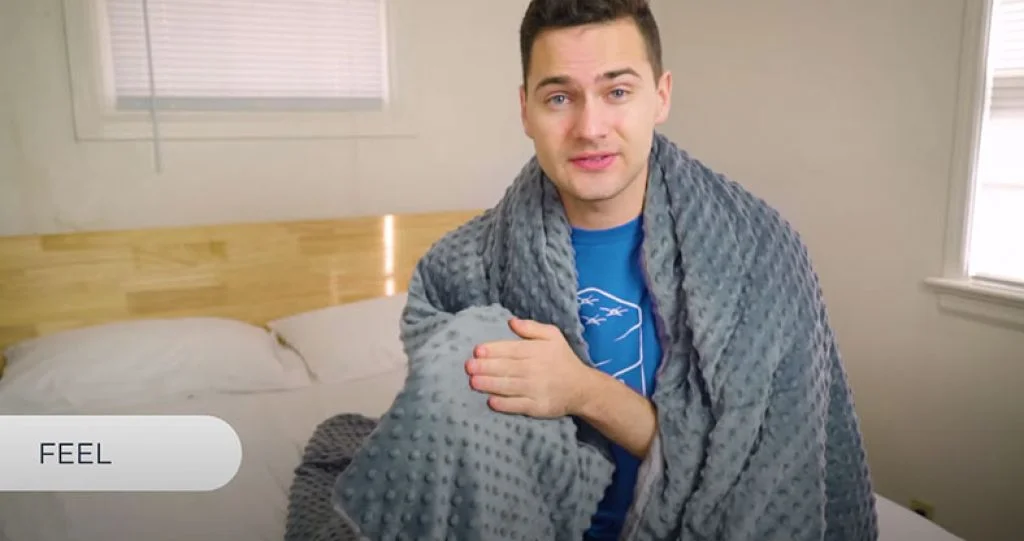 Our In-Depth Brooklyn Bedding Weighted Blanket Review for 2026 3 testing the feel of brooklyn bedding blanket