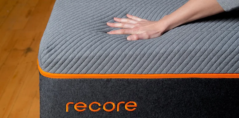 Our InDepth Recore Bed Review for 2026 5 the hand is squishing Recore mattress